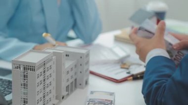 Emlakçı ve müşteri yeni bir ev, sigorta ve emlak konsepti satın alma sürecini tartışıyor