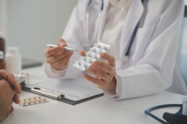 Healthcare service and pharmacy worker with customer at store counter for medication explanation. Pharmaceutical advice and opinion of pharmacist helping girl with medicine information.