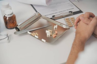 Healthcare service and pharmacy worker with customer at store counter for medication explanation. Pharmaceutical advice and opinion of pharmacist helping girl with medicine information.