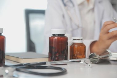 Healthcare service and pharmacy worker with customer at store counter for medication explanation. Pharmaceutical advice and opinion of pharmacist helping girl with medicine information.