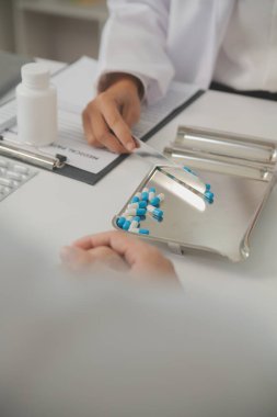 Healthcare service and pharmacy worker with customer at store counter for medication explanation. Pharmaceutical advice and opinion of pharmacist helping girl with medicine information.