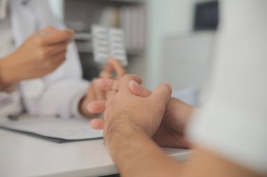 Healthcare service and pharmacy worker with customer at store counter for medication explanation. Pharmaceutical advice and opinion of pharmacist helping girl with medicine information.