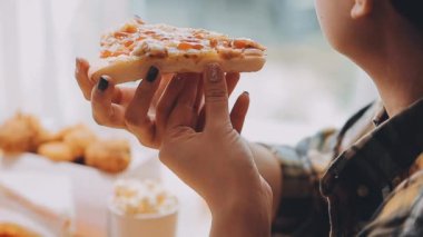 Kadın evde lezzetli fast food yiyor, yakın plan.
