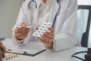 Healthcare service and pharmacy worker with customer at store counter for medication explanation. Pharmaceutical advice and opinion of pharmacist helping girl with medicine information.