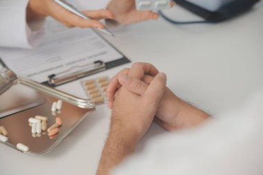 Healthcare service and pharmacy worker with customer at store counter for medication explanation. Pharmaceutical advice and opinion of pharmacist helping girl with medicine information.