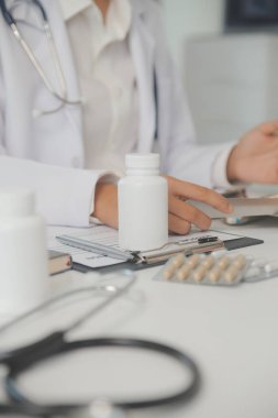 Healthcare service and pharmacy worker with customer at store counter for medication explanation. Pharmaceutical advice and opinion of pharmacist helping girl with medicine information.