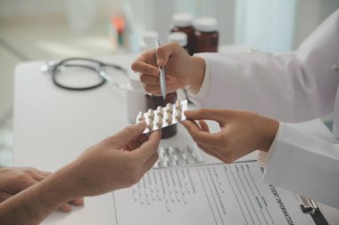 Healthcare service and pharmacy worker with customer at store counter for medication explanation. Pharmaceutical advice and opinion of pharmacist helping girl with medicine information.