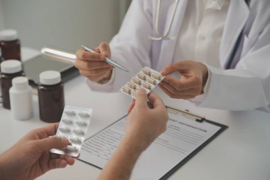 Healthcare service and pharmacy worker with customer at store counter for medication explanation. Pharmaceutical advice and opinion of pharmacist helping girl with medicine information.
