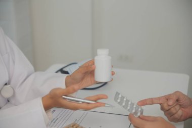 Healthcare service and pharmacy worker with customer at store counter for medication explanation. Pharmaceutical advice and opinion of pharmacist helping girl with medicine information.