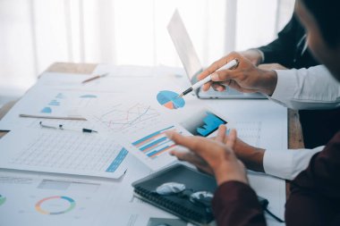 İş ekibi işbirliği mali veriler ve pazarlama büyüme raporlarıyla analiz etmeyi takım halinde, şirket kârından yararlanmak için strateji planlama, sunum ve beyin fırtınası grafiği üzerinde tartışır..