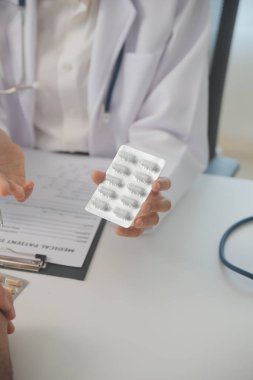 Healthcare service and pharmacy worker with customer at store counter for medication explanation. Pharmaceutical advice and opinion of pharmacist helping girl with medicine information.