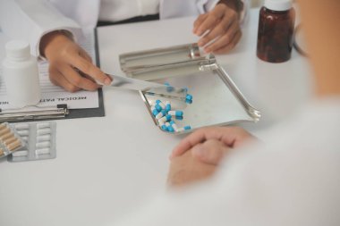 Healthcare service and pharmacy worker with customer at store counter for medication explanation. Pharmaceutical advice and opinion of pharmacist helping girl with medicine information.