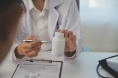 Healthcare service and pharmacy worker with customer at store counter for medication explanation. Pharmaceutical advice and opinion of pharmacist helping girl with medicine information.