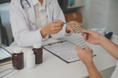 Healthcare service and pharmacy worker with customer at store counter for medication explanation. Pharmaceutical advice and opinion of pharmacist helping girl with medicine information.
