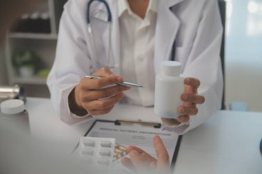 Healthcare service and pharmacy worker with customer at store counter for medication explanation. Pharmaceutical advice and opinion of pharmacist helping girl with medicine information.