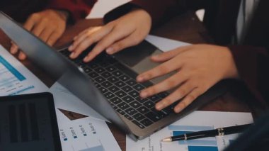 Genç iş adamı ofiste dizüstü bilgisayar kullanıyor.