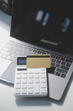 Koyu arkaplan, plastik kartlar ve banknotlar üzerindeki hesap makinesi