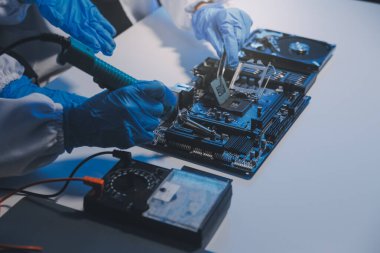 Close up of Technician measuring voltage electronic circuit board television, Service after sale fix electric equipment within insurance.