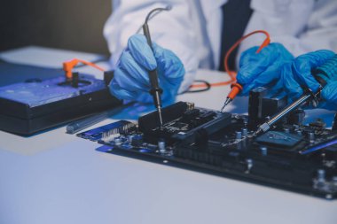 Close up of Technician measuring voltage electronic circuit board television, Service after sale fix electric equipment within insurance.