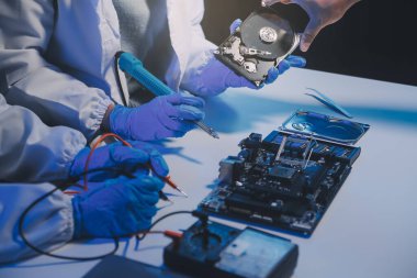 Close up of Technician measuring voltage electronic circuit board television, Service after sale fix electric equipment within insurance.
