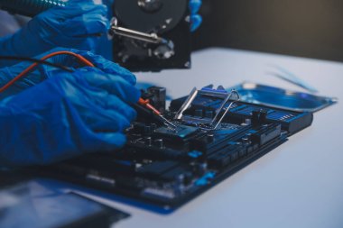 Close up of Technician measuring voltage electronic circuit board television, Service after sale fix electric equipment within insurance.