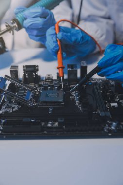 Close up of Technician measuring voltage electronic circuit board television, Service after sale fix electric equipment within insurance.