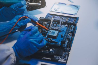 Close up of Technician measuring voltage electronic circuit board television, Service after sale fix electric equipment within insurance.