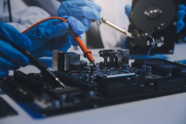 Close up of Technician measuring voltage electronic circuit board television, Service after sale fix electric equipment within insurance.