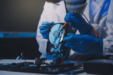 Close up of Technician measuring voltage electronic circuit board television, Service after sale fix electric equipment within insurance.