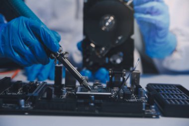 Close up of Technician measuring voltage electronic circuit board television, Service after sale fix electric equipment within insurance.