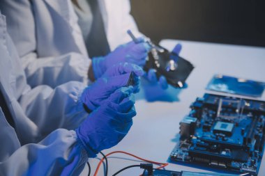 Close up of Technician measuring voltage electronic circuit board television, Service after sale fix electric equipment within insurance.