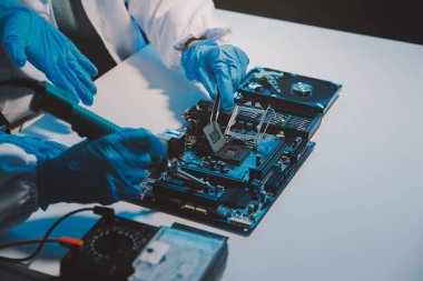 Close up of Technician measuring voltage electronic circuit board television, Service after sale fix electric equipment within insurance.