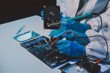 Close up of Technician measuring voltage electronic circuit board television, Service after sale fix electric equipment within insurance.