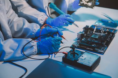 Close up of Technician measuring voltage electronic circuit board television, Service after sale fix electric equipment within insurance.
