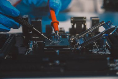 Close up of Technician measuring voltage electronic circuit board television, Service after sale fix electric equipment within insurance.