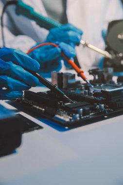 Close up of Technician measuring voltage electronic circuit board television, Service after sale fix electric equipment within insurance.