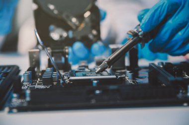 Close up of Technician measuring voltage electronic circuit board television, Service after sale fix electric equipment within insurance.