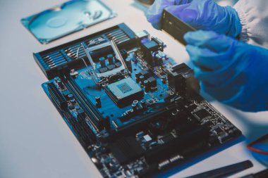 Close up of Technician measuring voltage electronic circuit board television, Service after sale fix electric equipment within insurance.