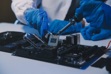 Close up of Technician measuring voltage electronic circuit board television, Service after sale fix electric equipment within insurance.