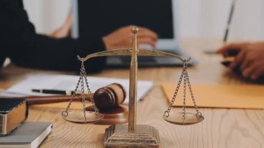 Yargıç tokmak ve adalet terazisi mahkeme masasında.