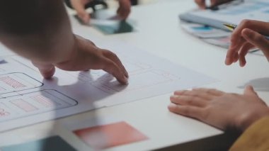 UX ya da UI tasarımcılarından oluşan bir grup masadaki modelleme prototiplerine sahip yeni bir uygulama tasarlıyor