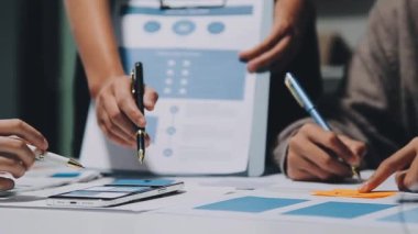 Yeni mobil uygulama ve web sitesi için renkli UX modelleri ve prototipleriyle çalışan tasarımcı takımı