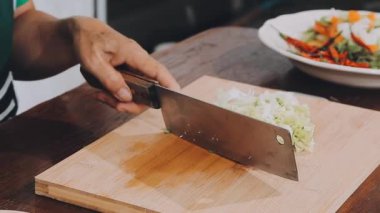 Şef evde salata için yemek pişiriyor.