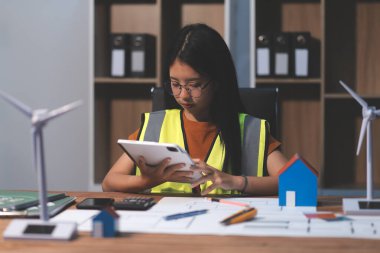 Evde çalışan kadın mimar planlara baktı..