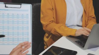 Finansal belgeler ve çizelgeler üzerinde çalışan bir iş adamı ekibi son model bir ofiste çalışıyor..