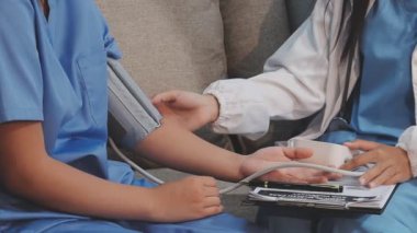 Hastanedeki bir çocuğun tansiyonunu ölçen doktor.