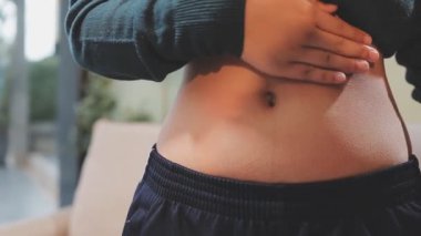 Karın ağrısı olan genç bir kadın..