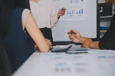 Finansal analistler, şirketlerin başarılı takım çalışmalarının sonuçlarını gösteren bir toplantıda bir dijital tablet planlama yatırım projesinin ticari mali raporlarını analiz ediyorlar..