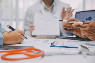 Görüşme, tablet ve doktorlardan oluşan bir ekip sağlık hizmetlerinden ve tele-sağlık uygulamalarından konuşmak için ofiste. Hastane finansmanı veya sponsorluğu için internet sitesiyle cerrah grubu, teknik ve tıbbi tartışmalar