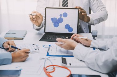 Görüşme, tablet ve doktorlardan oluşan bir ekip sağlık hizmetlerinden ve tele-sağlık uygulamalarından konuşmak için ofiste. Hastane finansmanı veya sponsorluğu için internet sitesiyle cerrah grubu, teknik ve tıbbi tartışmalar